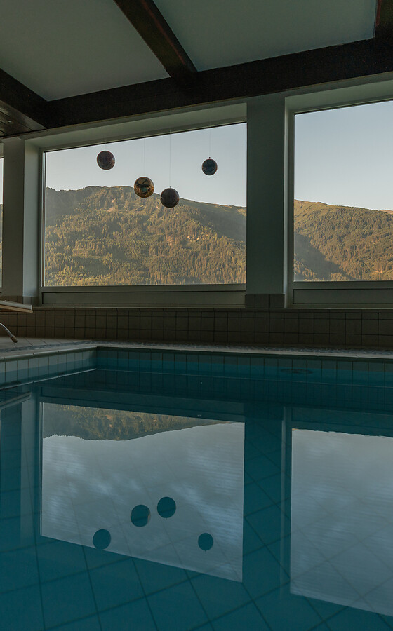 Indoor pool and sauna area with mountain view